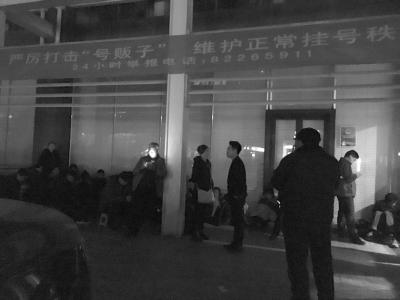 門診大樓左側(cè)特需掛號處有十幾名號販子在排隊(duì)，上方掛著“打擊號販子”的橫幅。
